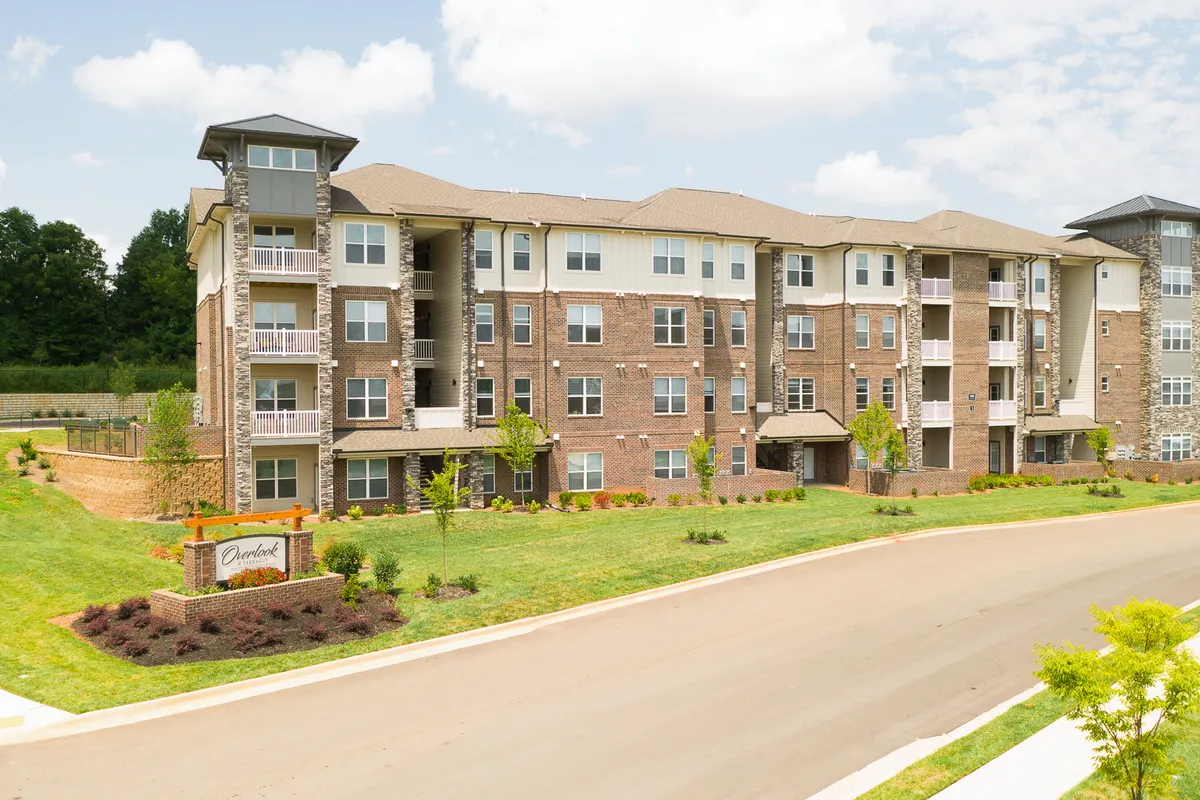 This shot captures the modern architecture of the apartment complex, with landscaped gardens and private balconies. The inviting outdoor spaces are perfect for picnics, outdoor gatherings, and evening strolls, emphasizing the property’s blend of urban accessibility and natural beauty.